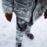 A worker poses in his frozen clothes. 