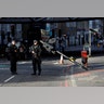 Armed police officers stand near the site where attackers crashed their van after running over pedestrians on London Bridge