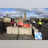 Pedestrians walk past newly erected barriers separating the road from the pavement on Westminster Bridge