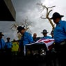 Honor guards carry the coffin of Puerto Rican police officer Luis Angel Gonzalez Lorenzo who was killed while trying to cross a river flooded by Hurricane Maria.
