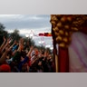 A float rider tosses beads during the Krewe of Bacchus Mardi Gras parade in New Orleans.