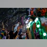  A float rider hands beads to a child during the Krewe of Bacchus Mardi Gras parade in New Orleans.