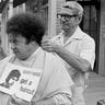 FILE - In this Aug. 15, 1968, file photo, comedian Marty Allen, fuzzy-haired member of the comedy team of Allen & Rossi, has his hair styled by barber Sol Goldstein in Hollywood, Calif. Allen's spokeswoman Candi Cazau says he died Monday, Feb. 12, 2018, of complications from pneumonia. His wife and performing partner Karon Kate Blackwell was by his side. He was 95. (AP Photo/Wally Fong, File)