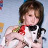 Mary Tyler Moore poses with a dog up for adoption at Broadway Barks