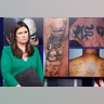 White House press secretary Sarah Huckabee Sanders stands in front of pictures of MS-13 gang tattoos