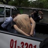 Members of the MS-13 gang are detained near the crime scene where two men were killed in San Salvador, El Salvador 