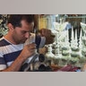 Man doing crafts inside his shop in Isfahan