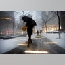 A man makes his way through wind and snow in New York's Zuccotti Park, Thursday, Feb. 9, 2017. 