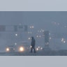 A pedestrian crosses a snow-covered intersection as snow falls, Thursday, Feb. 9, 2017, in Jersey City, N.J. 