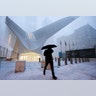 A man makes his way through wind and snow past the Oculus of the World Trade Center Transportation Hub, Thursday, Feb. 9, 2017, in New York.