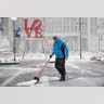 A man clears snow from Dilworth Park during a winter storm in Philadelphia, Thursday, Feb. 9, 2017. 