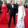 Moore escorts his wife Christina Tholstrup and daughter Deborah Moore on the red carpet at the 57th Cannes Film Festival, May 18, 2004