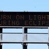 A sign on the highway refers to the upcoming solar eclipse near Guernsey, Wyoming, August 19