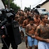 Mara Salvatrucha gang are guarded by policemen upon their arrival at the Quezaltepeque jail, El Salvador
