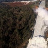 A damaged spillway with eroded hillside is seen in an aerial photo taken over the Oroville Dam.