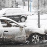 A policeman investigates a burnt car in Rinkeby, outside Stockholm, Sweden February 21, 2017.