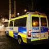 A police car is seen as several cars were set on fire during a riot in Rinkeby, outside Stockholm, Sweden.