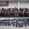 Members of the Barrio 18 gang are presented to the media after a police raid at La Campanera neighborhood in Soyapango 