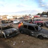 People look at a burnt car after an explosion at the San Pablito fireworks market outside Mexico City.