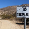 A sign stands on a private property near the U.S.-Mexico border fence near Jacumba, California.