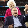 Former U.S. President George H.W. Bush participates in the coin toss ahead of the start of Super Bowl LI between the New England Patriots and the Atlanta Falcons as former first lady Barbara Bush looks on in Houston , Texas