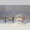 A snowplow drives through Times Square as snow falls in New York.