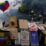 Opposition supporters use homemade shields to protect themselves while clashing with riot security forces in Venezuela
