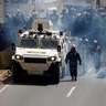 Riot security forces take position while clashing with opposition supporters rallying against Maduro in Caracas, Venezuela