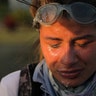 A protester reacts after being treated for tear gas exposure during clashes with riot security forces 