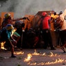 An opposition supporter throws a gasoline bomb while clashing with riot security forces during a rally in Caracas, Venezuela