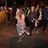 Concertgoers react after fleeing the Manchester Arena in northern England where Ariana Grande had been performing. 