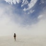 A lone Burning Man participant cycles through a desert dust storm at the annual Burning Man arts and music festival in Nevada, August 30