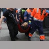 An injured person is helped by emergency services outside Sennaya Ploshchad metro station in Russia.