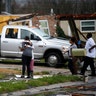 People hug after a tornado tore through the eastern part of New Orleans.