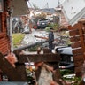 A man walks down the street past destroyed homes after a tornado tore through the eastern part of New Orleans.