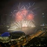 Fireworks explode above Singapore's financial district at the stroke of midnight to mark the New Year's celebrations 