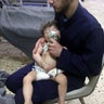 A medical worker giving toddlers oxygen through respirators following a poison gas attack in the opposition-held town of Douma.