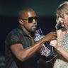 Singer Kanye West takes the microphone from singer Taylor Swift as she accepts the 