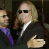 Musician Ringo Starr, greets musician Tom Petty as he arrives for a screening of 