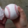 This photo shows a baseball and a hailstone that fell in the backyard a home in Ottawa, Illinois, Tuesday, Feb. 28, 2017. 
