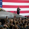 President Trump applauds on stage after speaking at a hangar rally at Yokota Air Base on the outskirts of Tokyo, Japan.