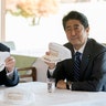 President Trump and Japanese Prime Minister Shinzo Abe display signed hats that say: 