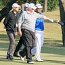 President Trump gestures to Japan's Prime Minister Shinzo Abe as Japanese professional golfer Hideki Matsuyama looks on.