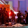 A body is covered with a sheet after a mass shooting at a music festival on the Las Vegas Strip, Sunday