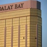 Drapes billow out of broken windows at the Mandalay Bay resort Monday, following a deadly shooting in Las Vegas
