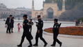 FILE - In this Nov. 4, 2017 file photo, Uighur security personnel patrol near the Id Kah Mosque in Kashgar in western China's Xinjiang region. China's northwestern region of Xinjiang has revised legislation to allow the detention of suspected extremists in "education and training centers." The revisions come amid rising international concern over a harsh crackdown in Xinjiang that has led to as many as 1 million of China's Uighurs and other Muslim minorities being held in internment camps. (AP Photo/Ng Han Guan, File)