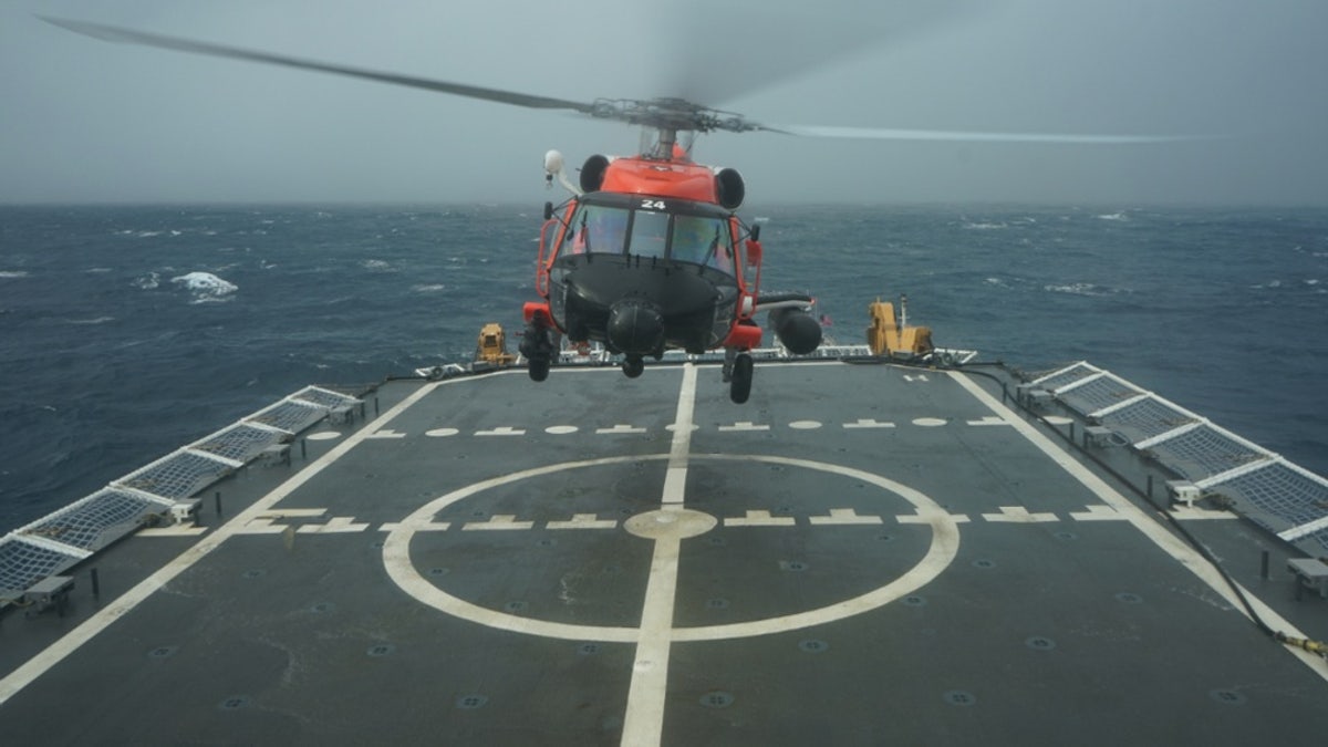 A Coast Guard rescue helicopter takes off from the deck of the Cutter Hamilton to continue searching for a missing civilian aircraft Oct. 27, 2018, 110 miles east of Charleston, South Carolina.