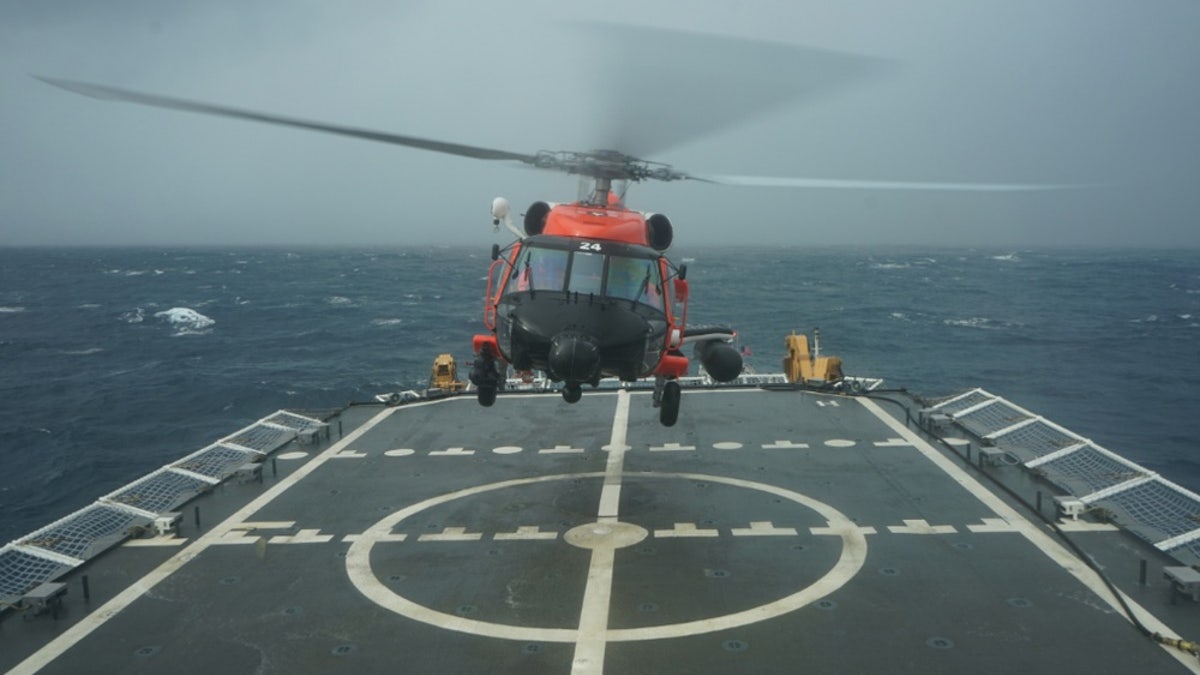 A Coast Guard rescue helicopter takes off from the deck of the Cutter Hamilton to continue searching for a missing civilian aircraft Oct. 27, 2018, 110 miles east of Charleston, South Carolina.
