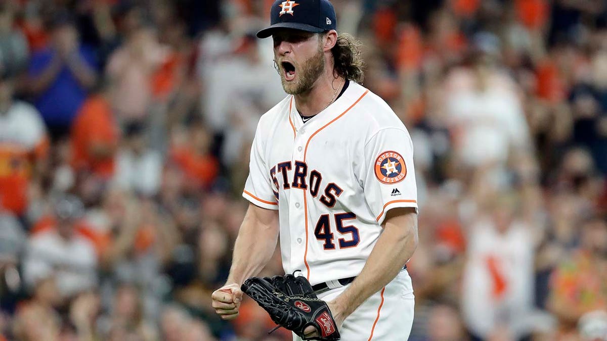 Houston Astros starting pitcher Gerrit Cole (45) reacts after striking out Cleveland Indians' Jose Ramirez to end the sixth inning of Game 2 of the American League Division Series, in Houston, Oct. 6, 2018.