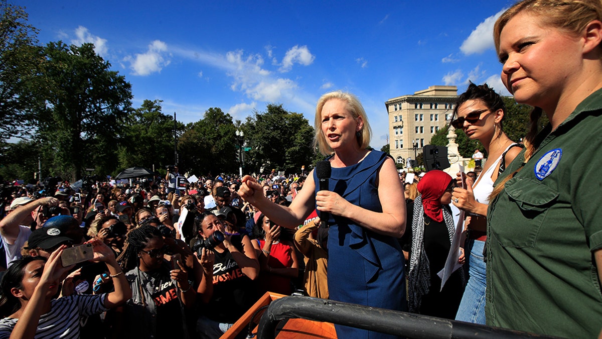 Sen. Kirsten Gillibrand, D-N.Y., with actress and comedian Amy Schumer, right, speaks at a rally against Supreme Court nominee Brett Kavanaugh at the Supreme Court in Washington, Thursday, Oct. 4, 2018. (AP Photo/Manuel Balce Ceneta)